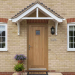 Wooden front door with house number 24B on a brick building