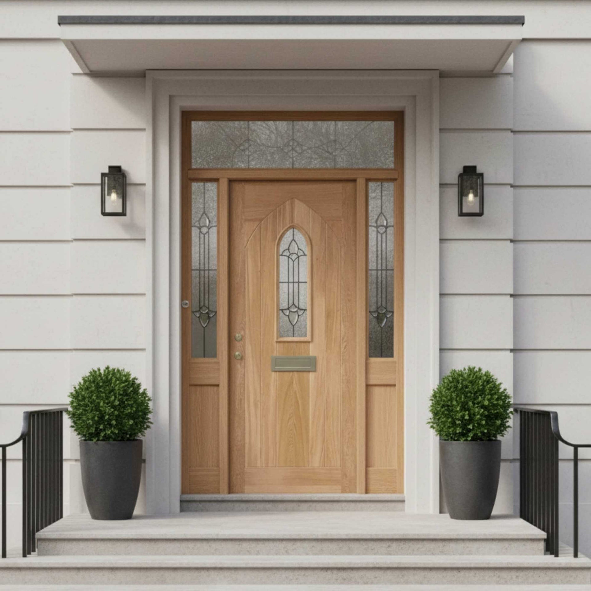 Wooden front door with decorative glass panels on a light gray house exterior.