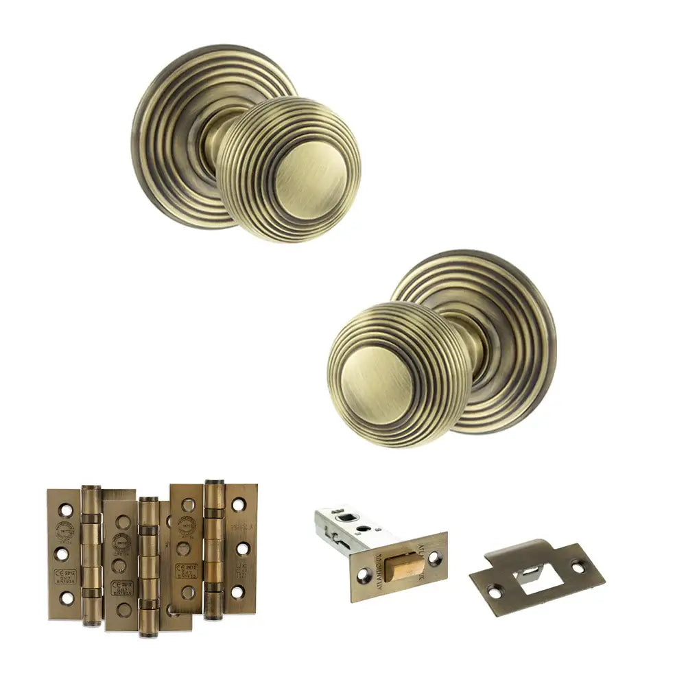 Pair of Ripon reeded beehive knobs in antique brass with hinges and tubular latch