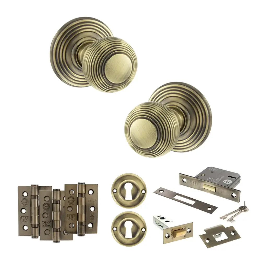 Pair of Ripon reeded beehive knobs in antique brass with hinges, sash lock and keys