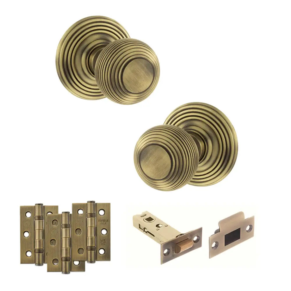 Pair of Ripon reeded beehive knobs in matt antique brass with hinges and tubular latch