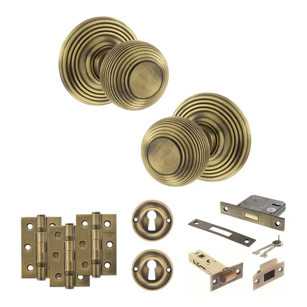 Pair of Ripon reeded beehive knobs in matt antique brass with hinges, sash lock and keys