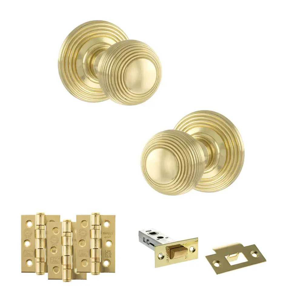 Pair of Ripon reeded beehive knobs in polished brass with hinges and tubular latch