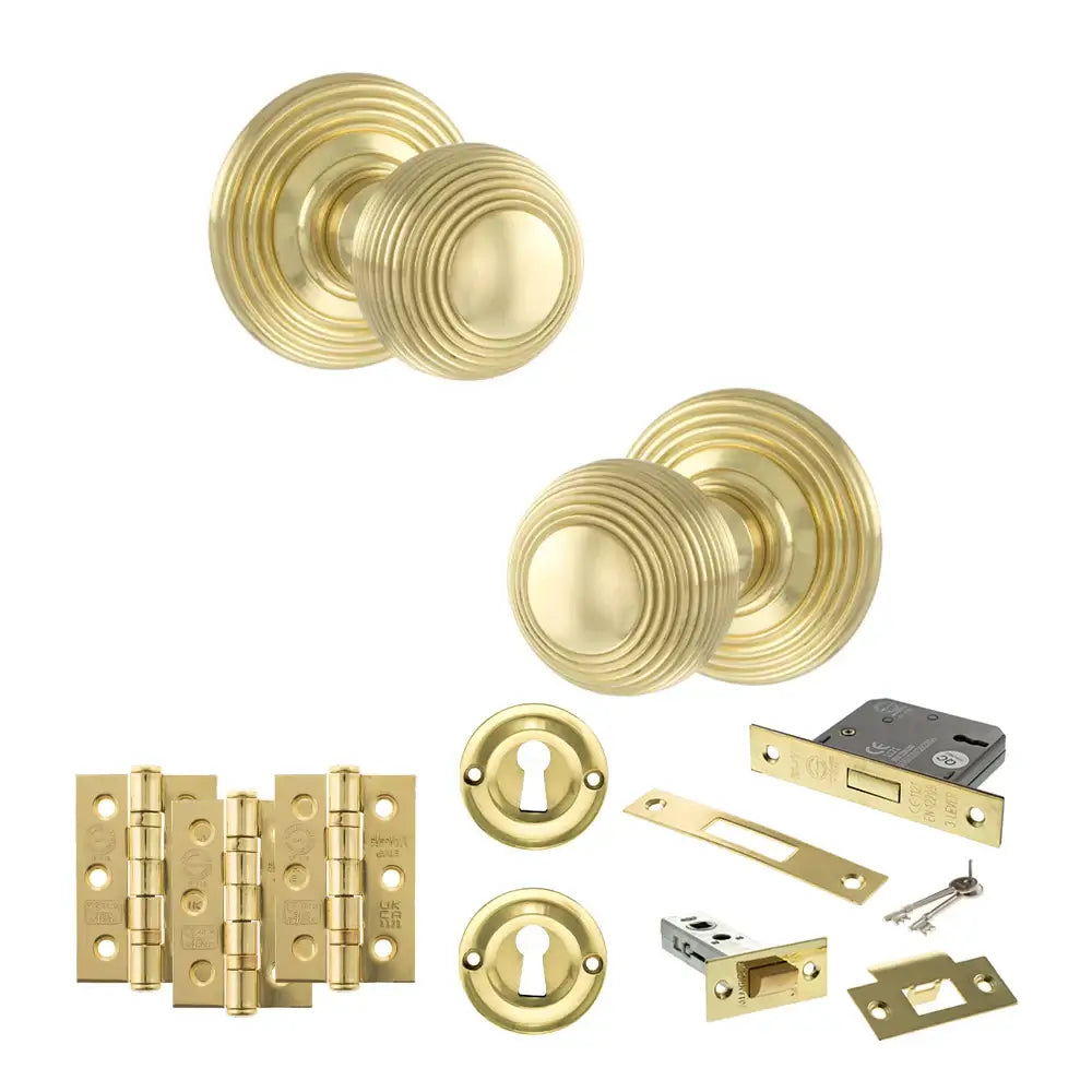 Pair of Ripon reeded beehive knobs in polished brass with hinges, sash lock and keys