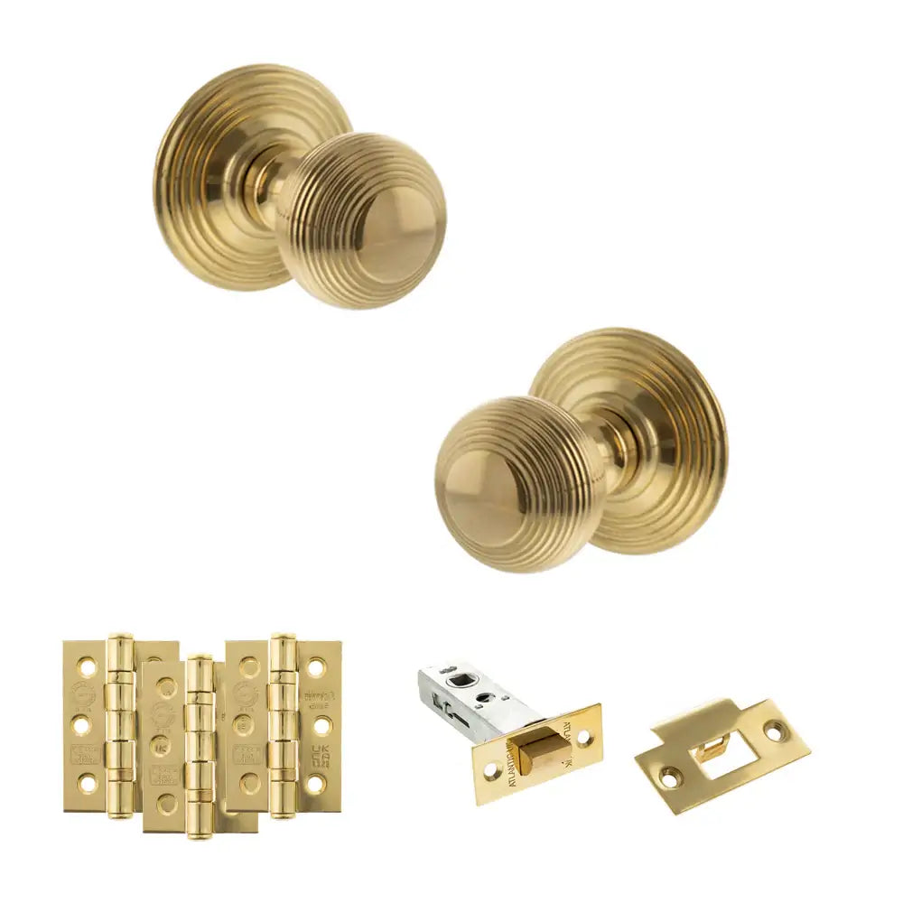 Pair of Ripon reeded beehive knobs in raw brass with hinges and tubular latch