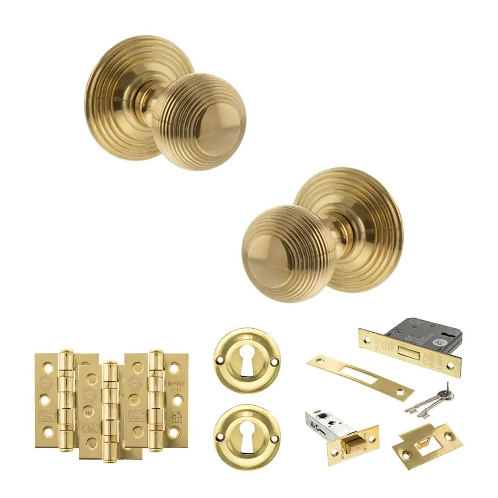 Pair of Ripon reeded beehive knobs in raw brass with hinges, sash lock and keys
