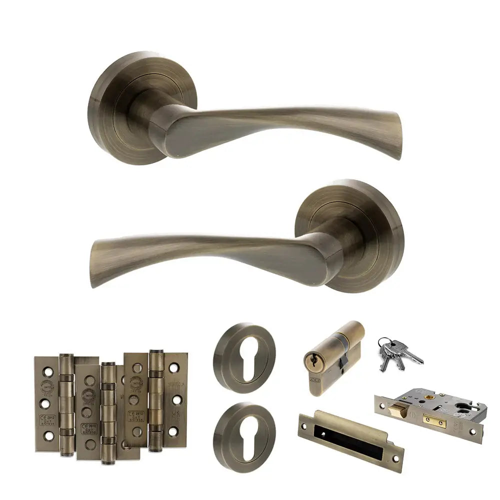 Product Set of bronze door handles, locks, and hinges on a white background