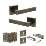 Product Set of bronze door handles, hinges, and lock mechanism on a white background