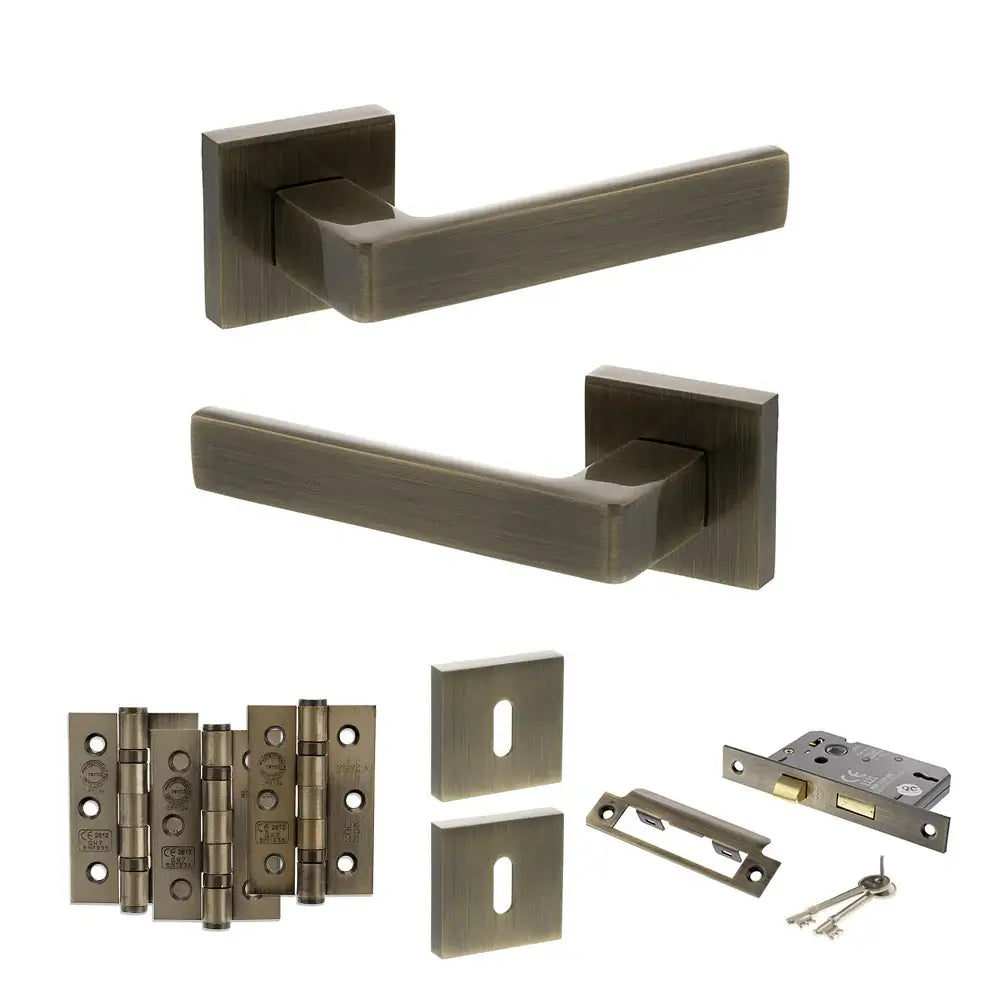 Product Set of bronze door handles, hinges, and lock mechanism on a white background