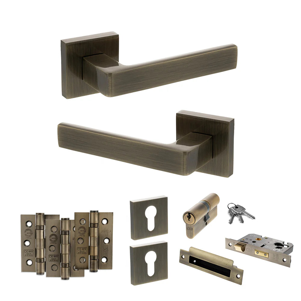 Product Set of bronze door handles, locks, and hinges on a white background