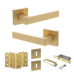 Product Set of gold door handles, hinges, and lock mechanism on a white background