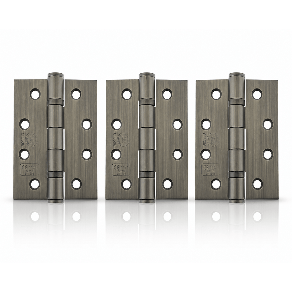 Product Three pairs of heavy-duty metal hinges in a brushed gunmetal finish, arranged side-by-side on a reflective white surface.