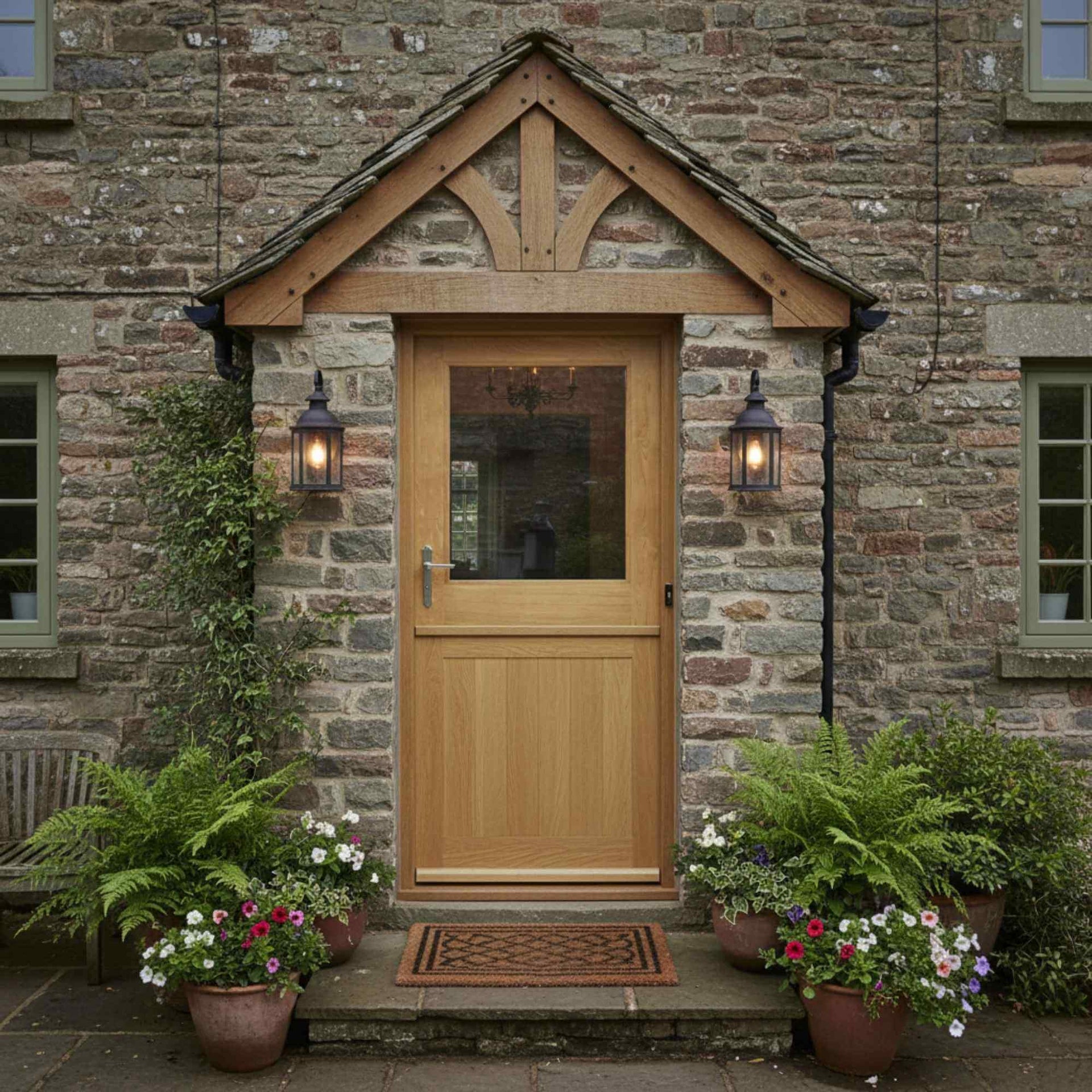 Wooden door with glass panels on a stone building, surrounded by potted plants.