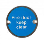 Product A circular blue fire door keep clear sign with white text and a dark metal frame, shown against a plain white background.