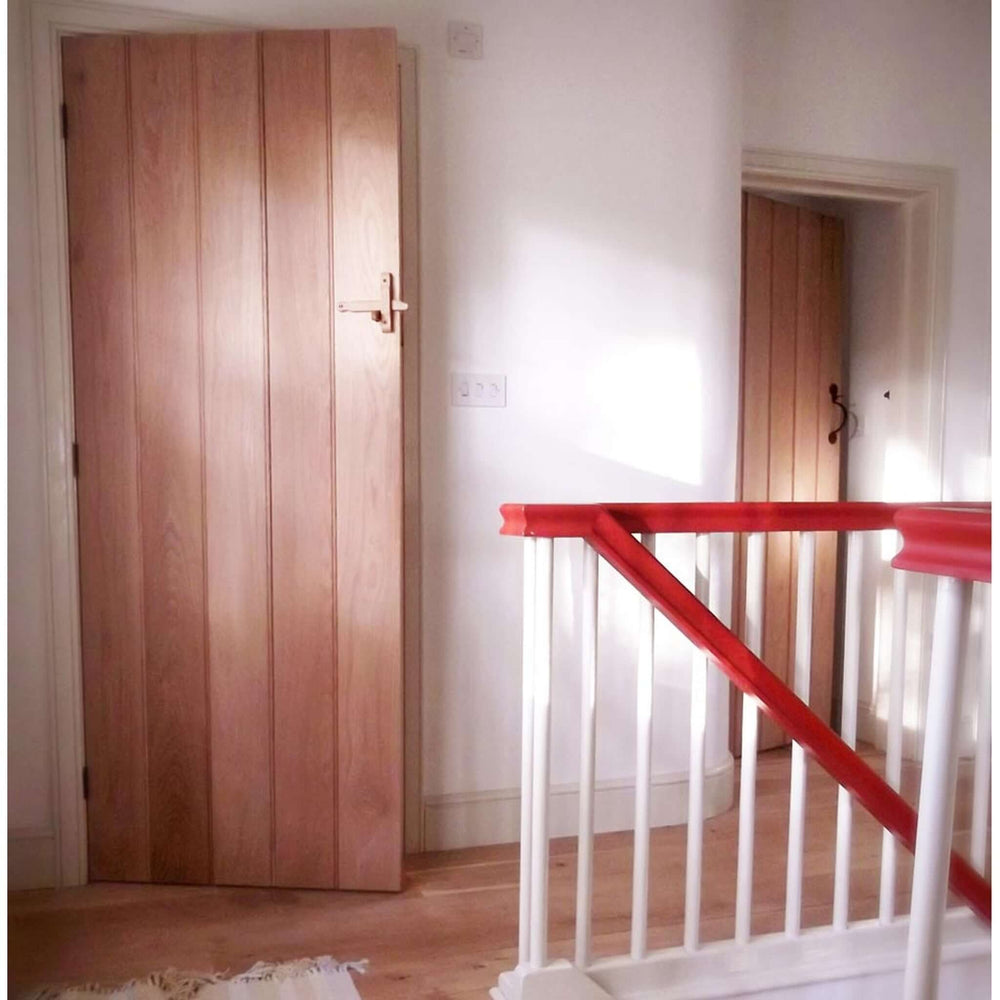 Lifestyle ledged barn hidden fixings solid oak door installed in a room setting