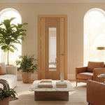 Living room with a wooden door, brown sofa, and decorative items.