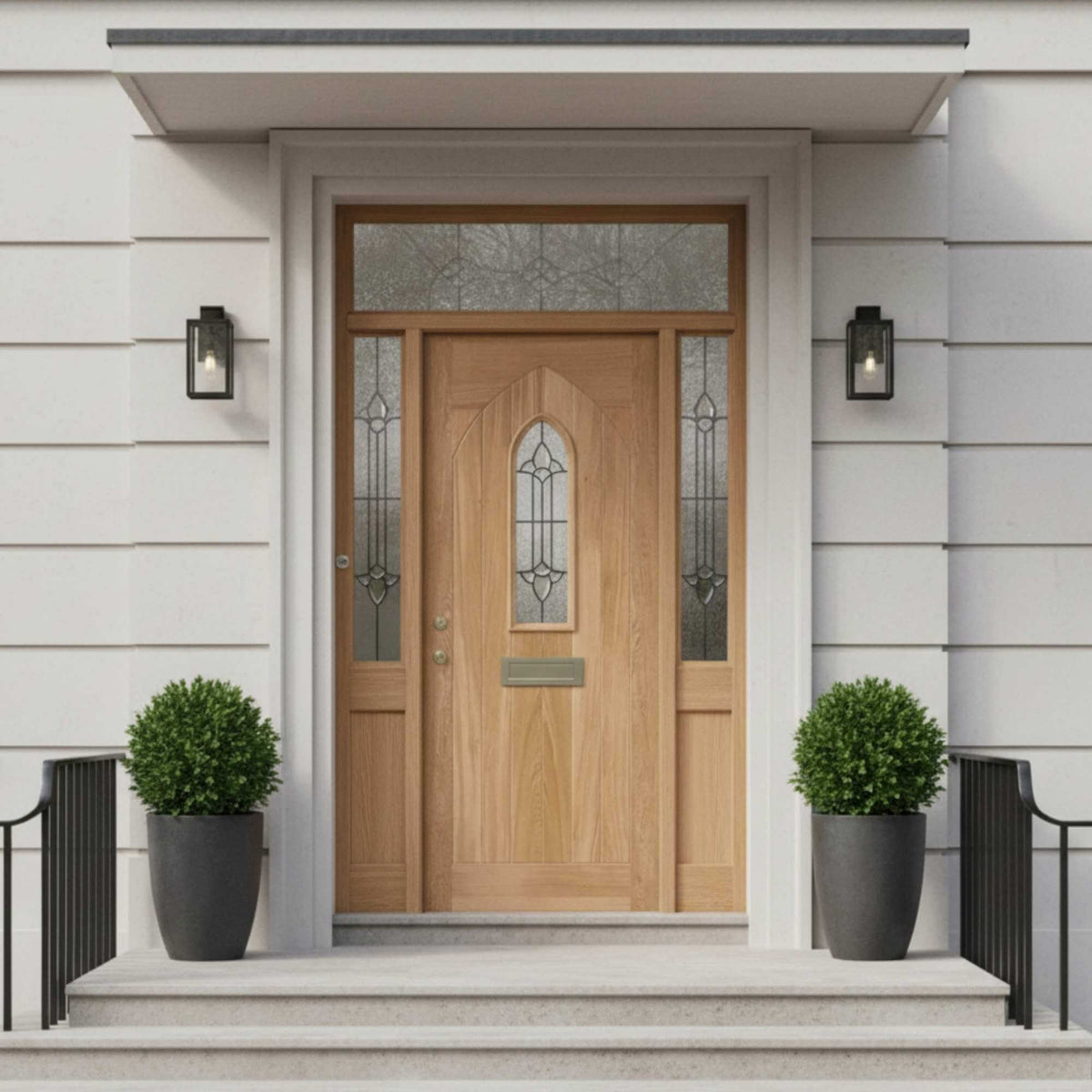Wooden front door with decorative glass panels on a light gray house exterior.