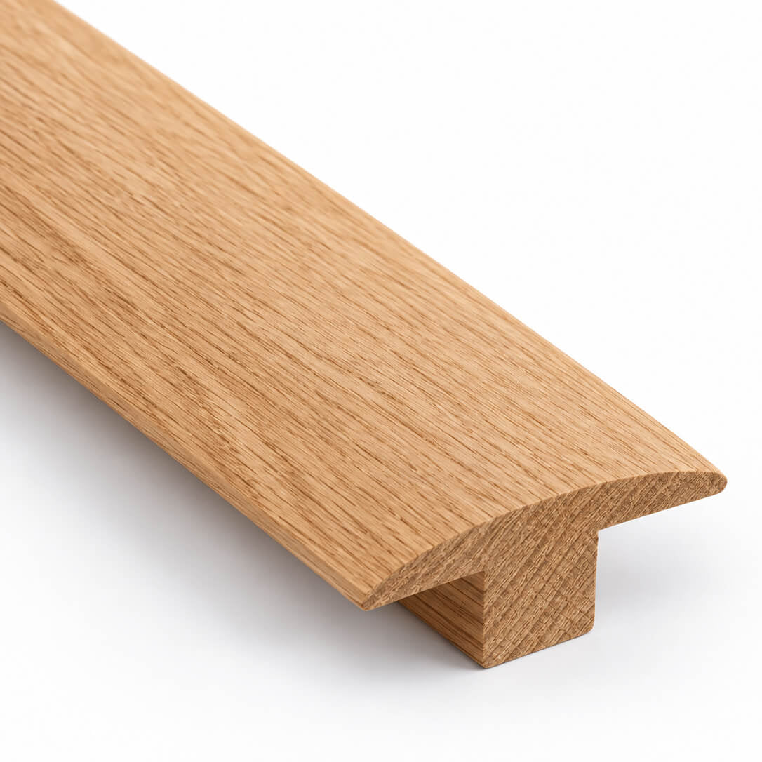 Product A close-up of a light oak wood trim piece with a T-profile cross-section, showing the natural wood grain texture on a clean white background.