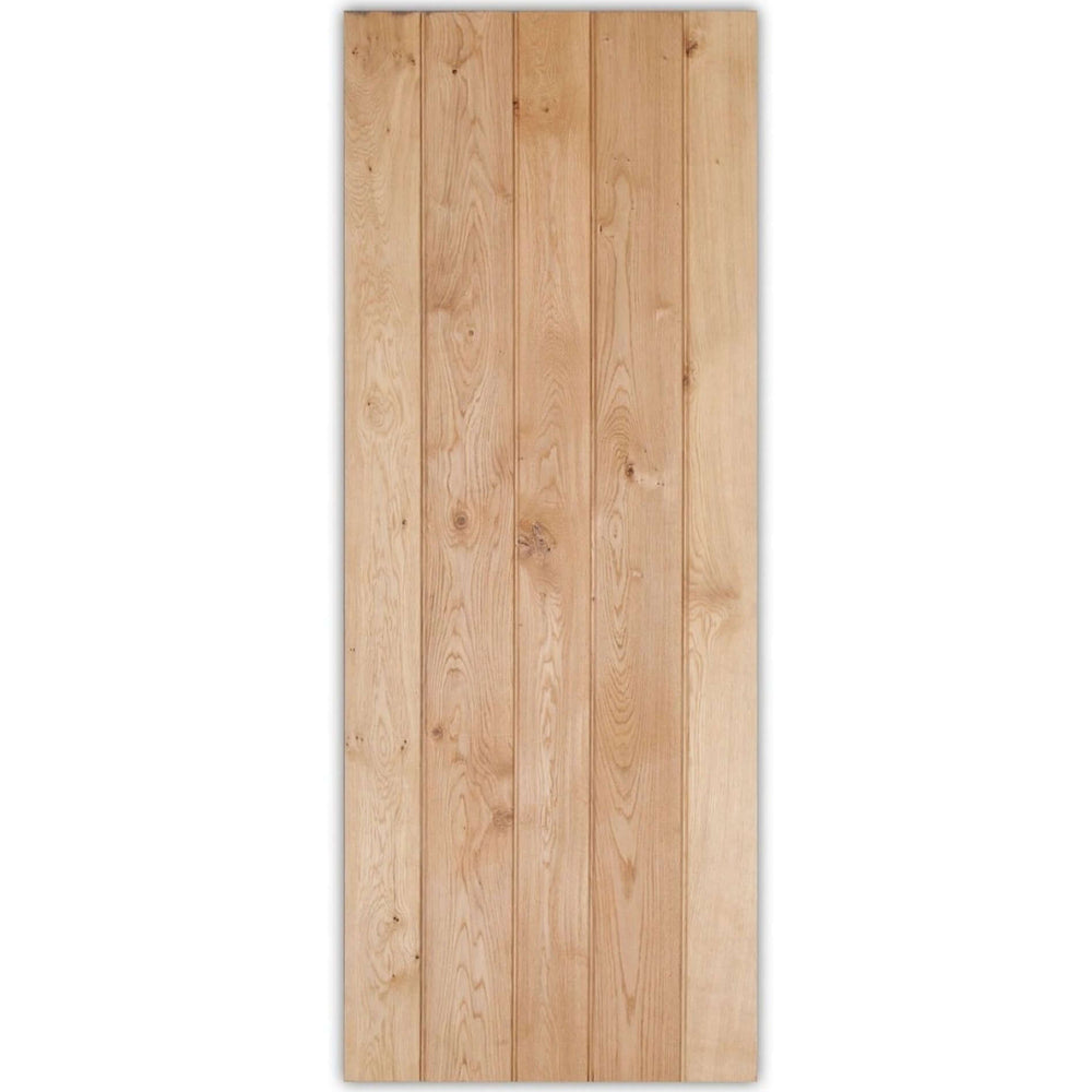 Lifestyle solid oak rustic three-ledged bead and butt barn door shown in an interior