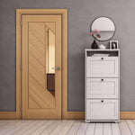 Wooden door with glass panel in a room with a white cabinet and decorative items.