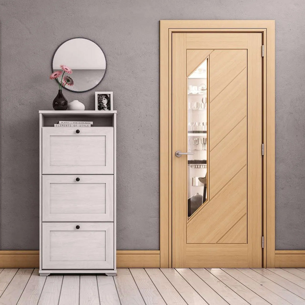 Wooden door with glass panel in a room with a white cabinet and decorative items.
