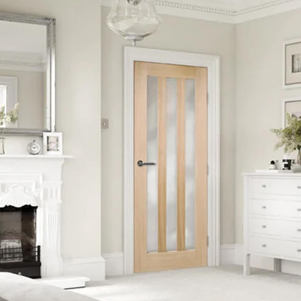 Wooden door with glass panels in a room with a fireplace and white furniture.
