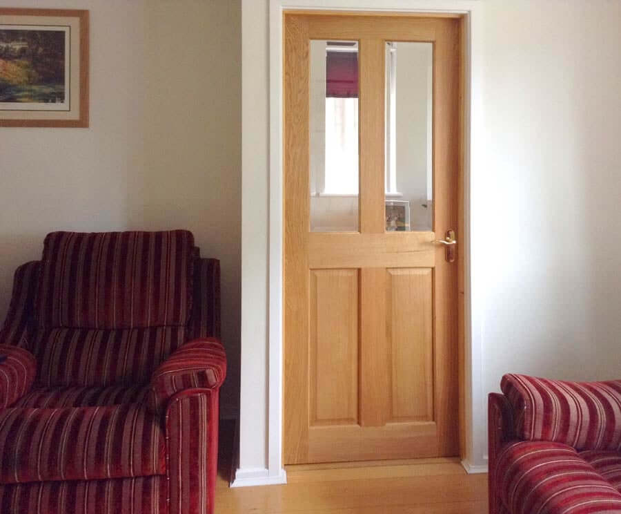 Lifestyle Victorian four panel glazed veneer oak door installed in a room